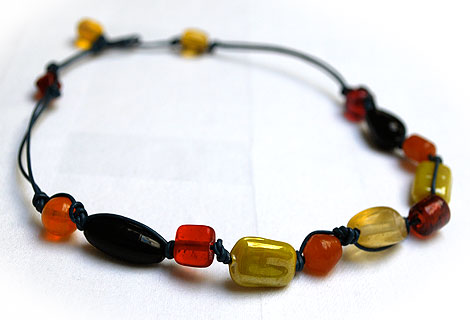 Beatrice necklace - Fun mixture of different coloured glass and ceramic beads and buttons. Strung and knotted with double cord and front fastened with a square button.