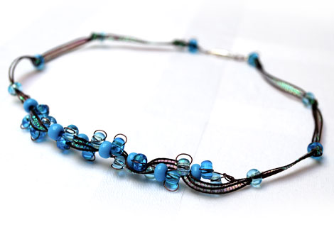 Joanne ribbon and wire threaded necklace - Beautiful combination of woven wire, iridescent maroon ribbon and blue beads make up this sparkling necklace. Fastened with a silver plated screw clasp. Matching bracelet and earrings available.
