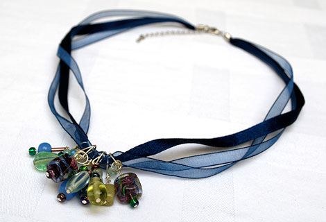 Amanda bead cluster pendant - Gorgeous cluster of blue, green and purple glass beads hanging from a necklace of three navy blue ribbons. Lobster clasp and chain.