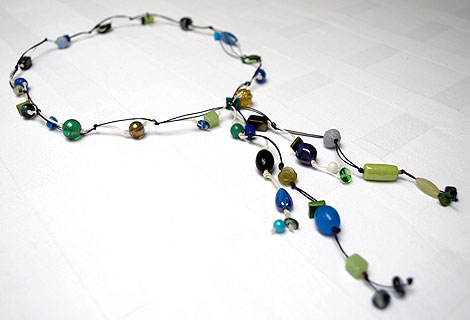 Mari Jo blue/green/purple long knotted lariat - Striking mixed bead lariat necklace designed to be worn to the navel. Strung and knotted onto double thread. Fixed front fastening.