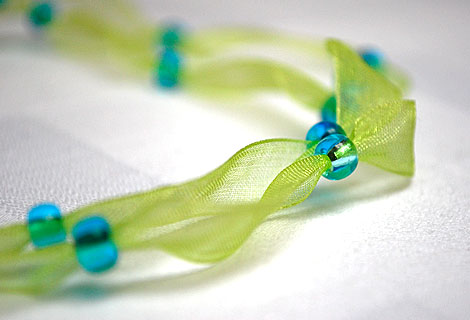 Freya ribbon necklace - Lovely bright green organza ribbon necklace. Two ribbons threaded at intervals with blue beads. Magnetic clasp.