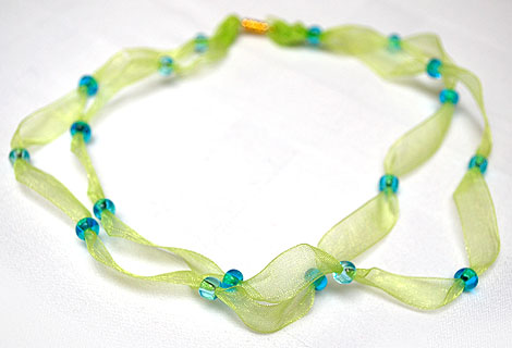 Freya ribbon necklace - Lovely bright green organza ribbon necklace. Two ribbons threaded at intervals with blue beads. Magnetic clasp.