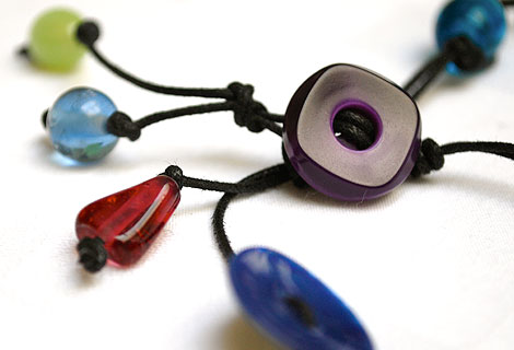Sammy knotted bead and button lariat - Fun mixture of different coloured glass beads and buttons. Strung and knotted with double black cord and front fastened with a square button.