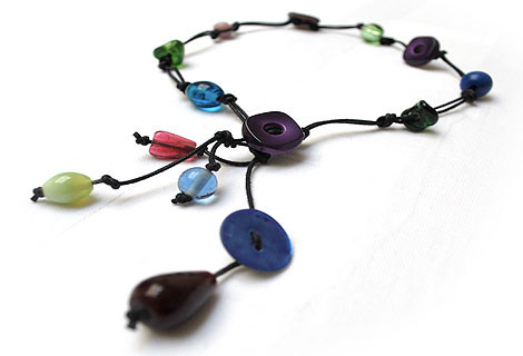 Sammy knotted bead and button lariat - Fun mixture of different coloured glass beads and buttons. Strung and knotted with double black cord and front fastened with a square button.