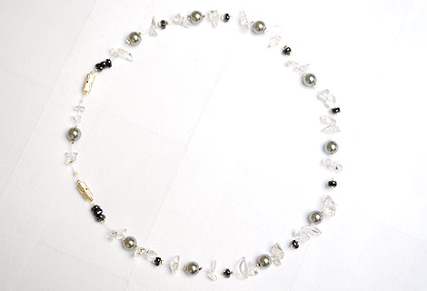 Nicola gem floating necklace - This exquisite necklace of pearlescent beads, semi-precious gems and organic-shaped black beads floats on your skin and adds a touch of glamour to any outfit. Strung onto clear illusion cord. Magnetic clasps with removable section to adjust length.