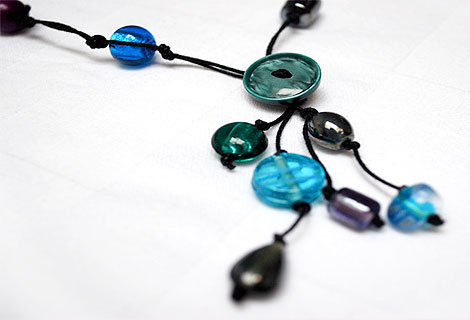 Sammy green knotted bead and button lariat - Fun mixture of different coloured glass beads and buttons. Strung and knotted with double black cord and front fastened with a round button.