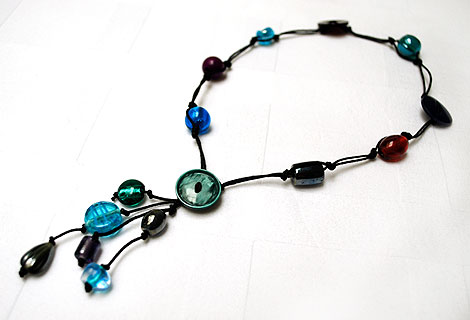 Sammy green knotted bead and button lariat - Fun mixture of different coloured glass beads and buttons. Strung and knotted with double black cord and front fastened with a round button.