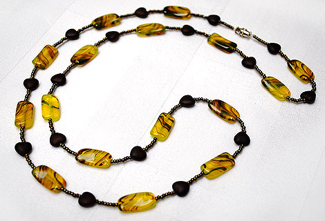 Amber necklace - Unusual rectangular Czech glass beads strung with metallic seed beads and chocolate brown hearts which can be worn long, as a single strand, or wrapped round twice. Screw clasp.