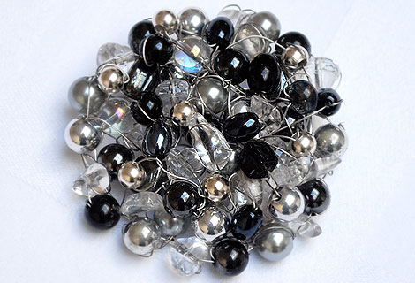 Betty large disc brooch - A stunning mixture of black, silver, grey and clear beads knitted together to form this gorgeous and unusual brooch.