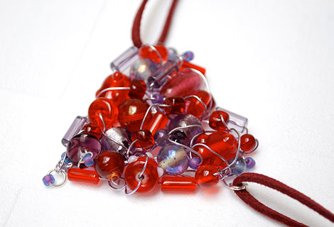 Scarlet heart pendant - A mixture of red and purple beads knitted together with lilac wire to form this gorgeous and unusual pendant, hanging from a double length of burgundy suede. Lobster clasp