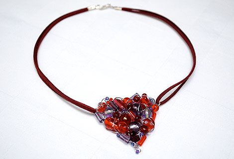 Scarlet heart pendant - A mixture of red and purple beads knitted together with lilac wire to form this gorgeous and unusual pendant, hanging from a double length of burgundy suede. Lobster clasp