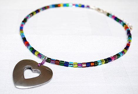 Madeleine heart pendant - Shiny heart pendant hanging from a necklace of sparkling multi-coloured Miyuki cube beads. Lobster clasp and chain.
