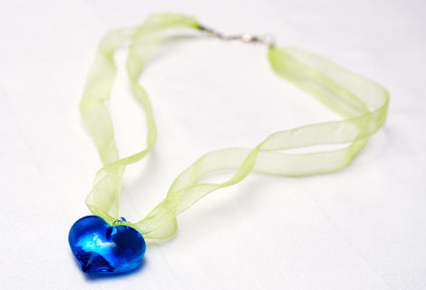 Sweetheart blue pendant - A clear glass heart strung onto organza ribbon. Fastened with a lobster clasp